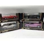 A collection of boxed, 1:18 scale, diecast vehicle