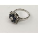 An unmarked, white gold sapphire and diamond clust