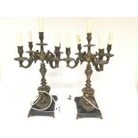 A pair of 20th century cast metal and bronze electric candelabra with four arms and one central