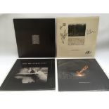 Four Joy Division vinyl records comprising a signe