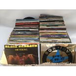 A box of 7inch singles by rock artists including B