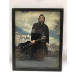 A signed photo of Johnny Cash, approx 22cm x 27cm.