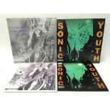 Three signed Sonic Youth singles and one unsigned