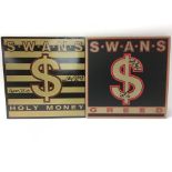 A signed copy of Holy Money by Swans and a signed