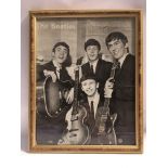 A framed poster of The Beatles circa 1963 signed t