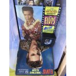 A box containing a collection of Elvis Presley mem