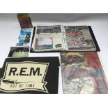 A collection of REM related items including a sign