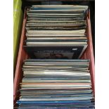 A crate of mainly jazz and classical LPs.