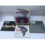 Nine Inch Nails CDs. A CD single signed by Trent Reznor, a deluxe edition of 'Damaged', 2CD deluxe
