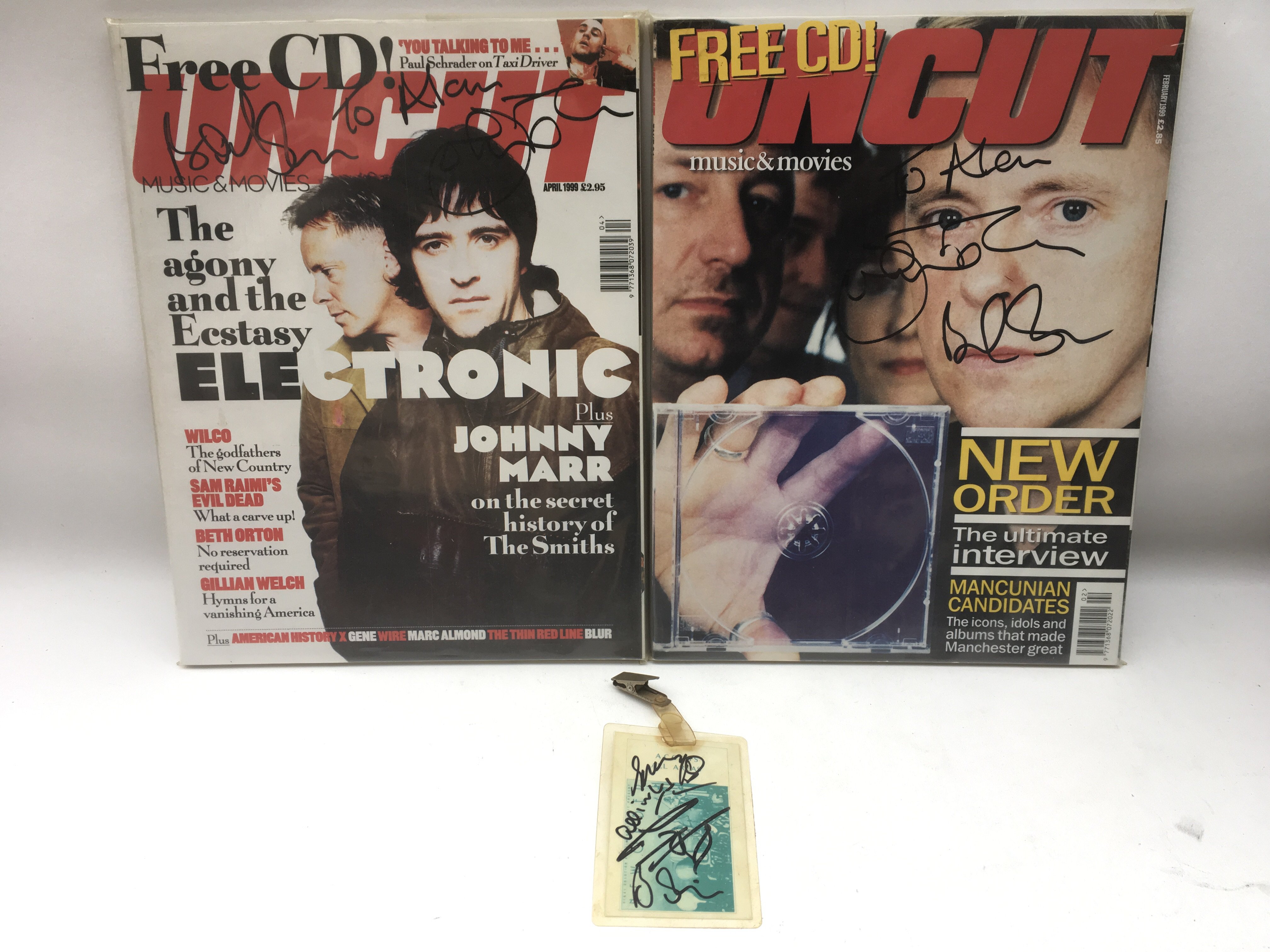 A signed New Order tour laminate plus two issues of Uncut signed by Bernard Sumner and Johnny Marr