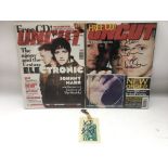 A signed New Order tour laminate plus two issues of Uncut signed by Bernard Sumner and Johnny Marr