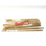 A collection of gig used drumsticks, some of them