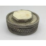 An oval Silver box with applied woven silver and p