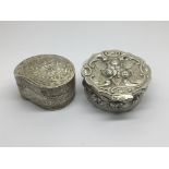 Two Silver boxes one with repousse chased decorati