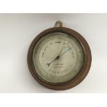 A small circular oak cased barometer, approx 18cm diameter in total - NO RESERVE