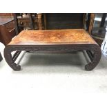A carved Chinese hardwood coffee table with curved legs. Measures approx 100cm x 46.5cm x 34.5cm