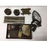 An Edwardian fishing kit containing lures, reels, line and other pieces in a wooden case.