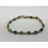 A 9ct gold bracelet set with sapphires and diamonds, approx 10.9g.