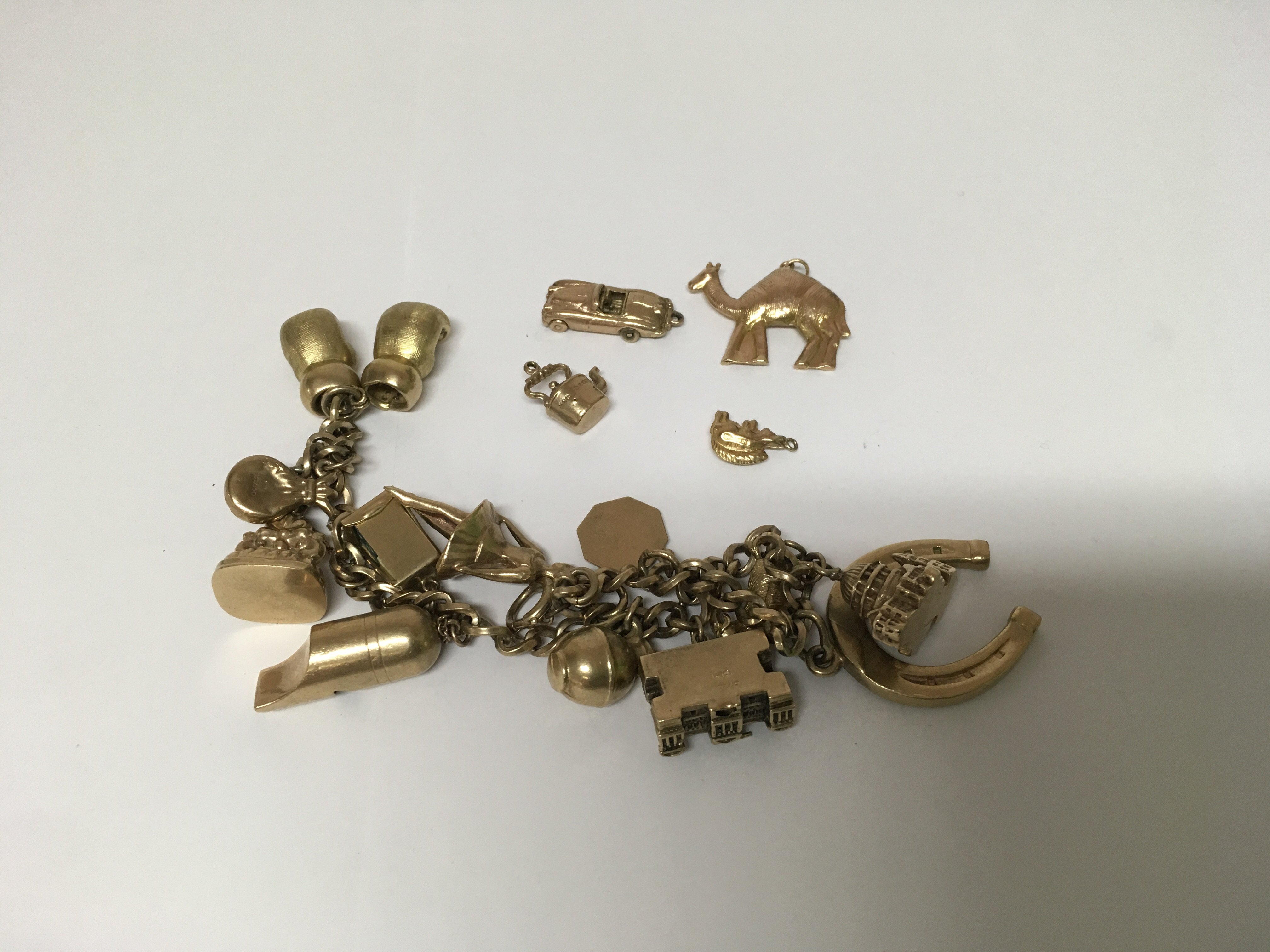 A 9ct gold charm bracelet 61 grams approx