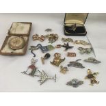 A collection of decorative brooches and a gilt button wind pocket watch