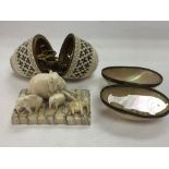 A late Victorian egg shaped ivory sewing case, a small group of ivory elephants and a mother of