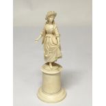 A Quality late 19th Century Carved ivory figure of a lady in traditional dress on a turned pedestal.
