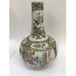 A canton bottle vase decorated with figures flowers and foliage, paint loss , no damage or