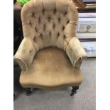 A Victorian button back chair on turned fluted legs