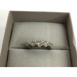 A gold and platinum ring set with a band of five diamonds.Approx Q/R