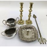 A pair of heavy brass candlesticks and silver plated odds