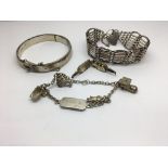 A group of silver jewellery to include a bangle, gate bracelet and a charm bracelet with the name
