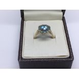 A modern 9ct gold ring in a fitted box set with an aquamarine coloured stone, approx 3.9g and approx