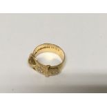 A 18 ct gold buckle ring inset with two diamonds 7.9 grams approx