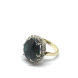 An 18ct gold ring set with a sugared opal in diamond surround.Approx