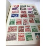 Two albums containing world stamps and loose stamps various