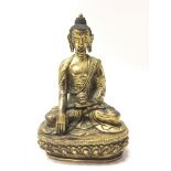 A gilt ornamental Buddha with marking to the base, approx 15cm tall.