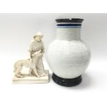 A bulbous textured vase alongside an ornament of a monk with a dog - NO RESERVE