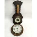 A circular oak cased aneroid barometer and one oth