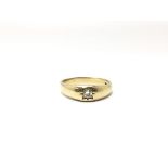 A 9ct gold gypsy ring set with a single central diamond, ring size V, weight approx 5 grams.