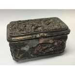 A Continental Early 20th Century trinket box decorated in raised relief. Containing three small