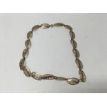 A 9ct gold necklace with shaped open links. Length approx 41cm. Weight approx 15.4g.
