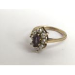 A 9ct gold ring set with central amethyst in pearl surround.Approx M