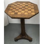 An octagonal checkerboard top table on pedestal base.Approx 47x47x72cm high, spilt to base