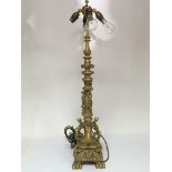 A Quality gilt metal lamp the tall column with raised masks and folate scrolls, later converted to