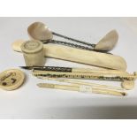 A collection of small ivory oddments including a shoe horn crochet hooks a fountain pen and two