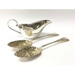 A cased pair of silver berry spoons and a silver cream jug. Total weight approx 195 grams.