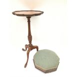 A satin wood occasional table on three legs, alongside a petite octagonal foot stall.