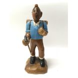 A carved wooden figure of Tin Tin, measures approx 31cm tall.