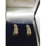 A pair of 9ct and diamond set hoop earrings