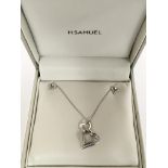 A 9ct white gold and diamond heart set necklace and earring set